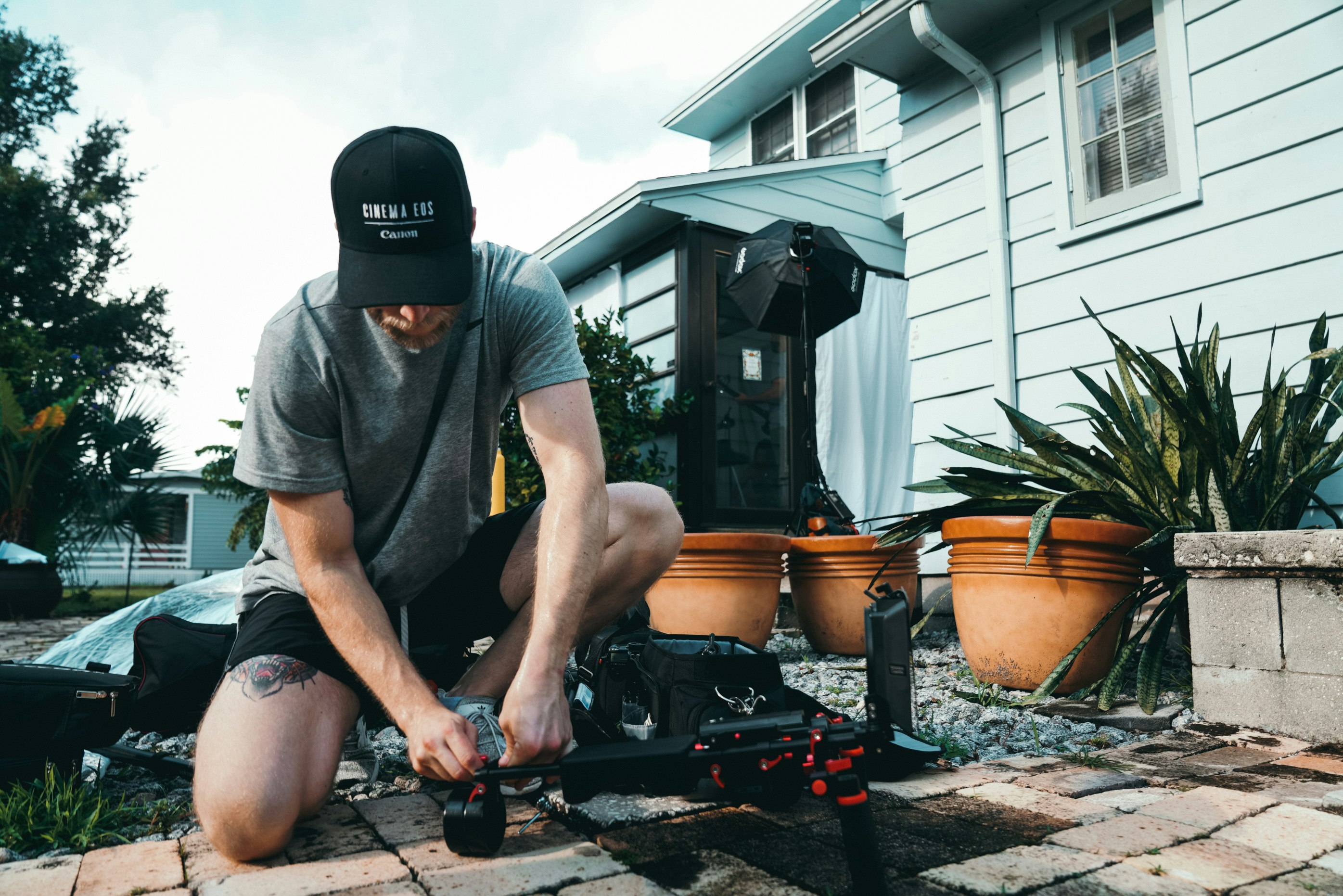 kneeling man fixing black wheeled bar